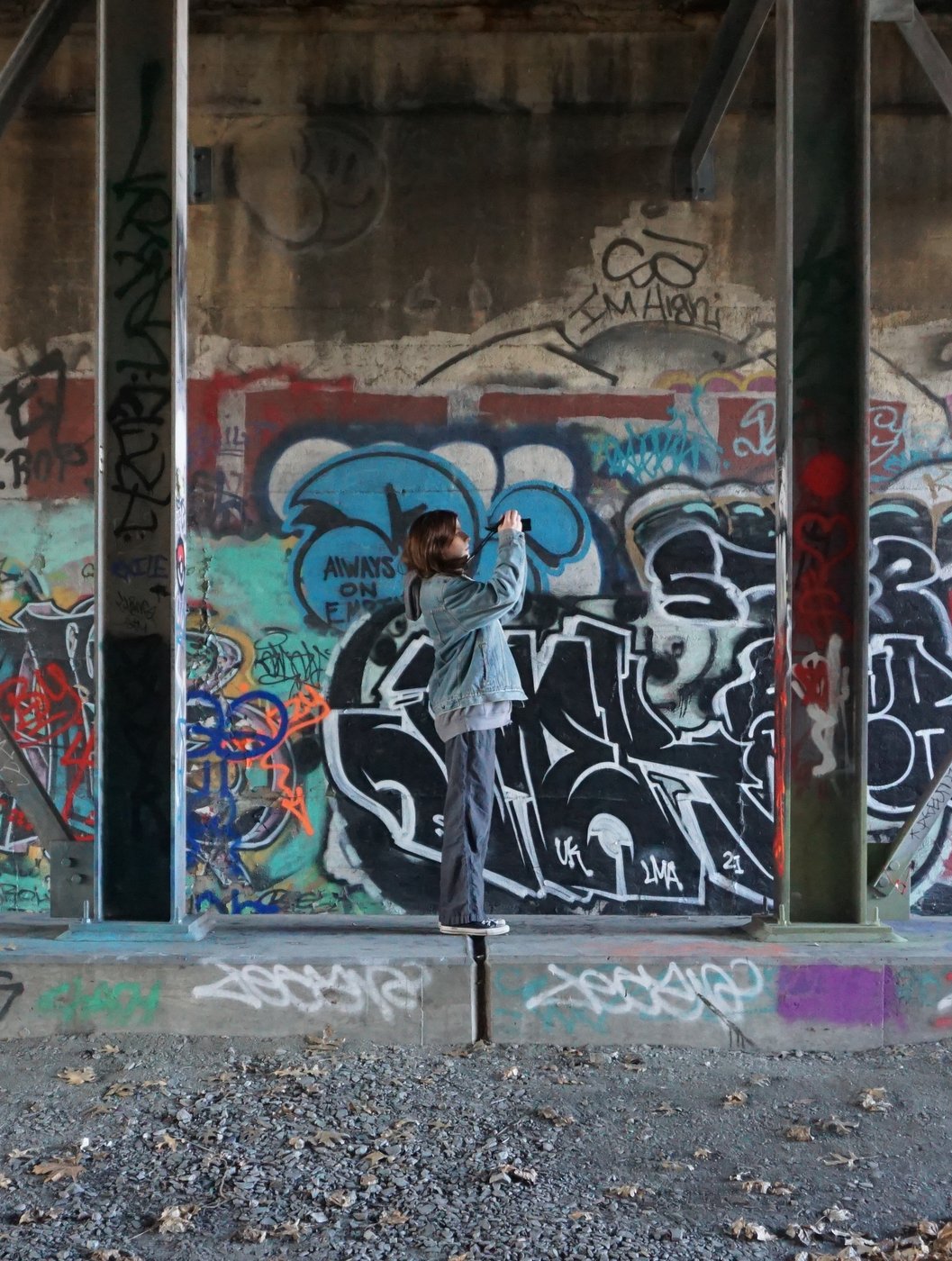 Mia Sibley photographing a graffiti wall